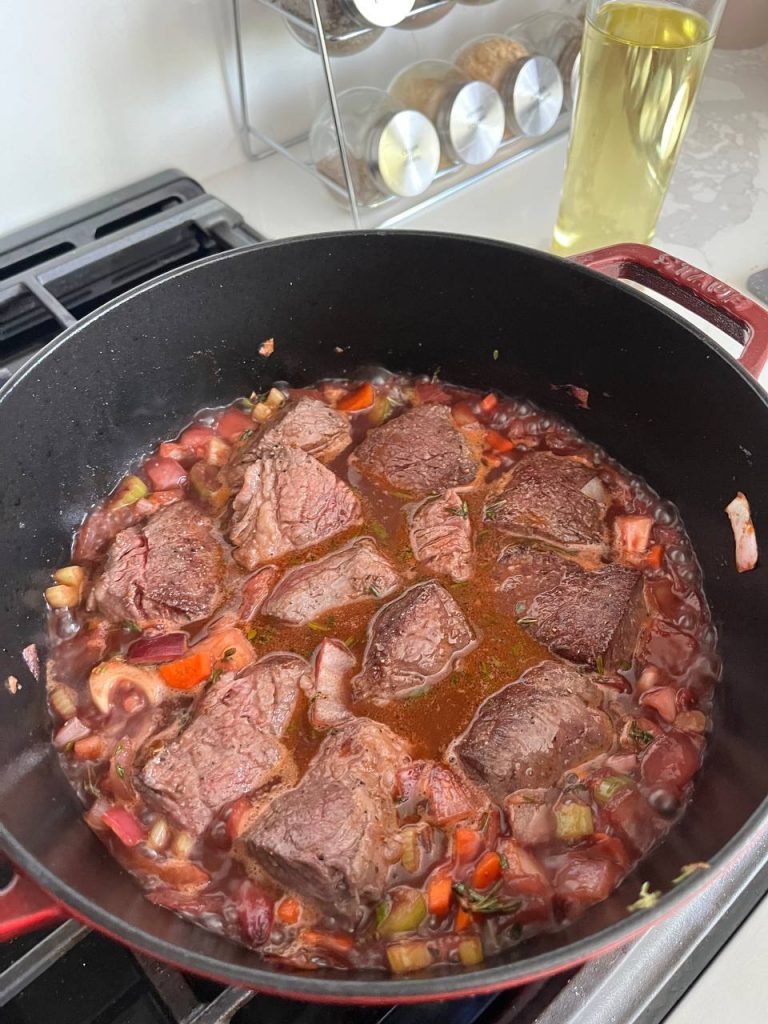 Black coating of Staub dutch oven while cooking